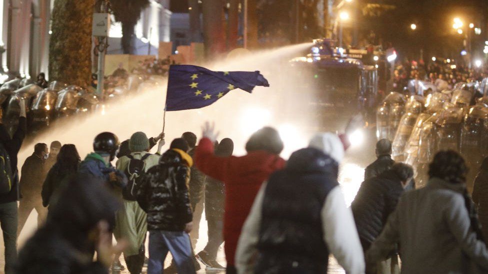 Riot police use water cannon and tear gas to disperse protesters gathered outside parliament building during a protest against bill on foreign influence transparency in Tbilisi, Georgia on March 07, 2023