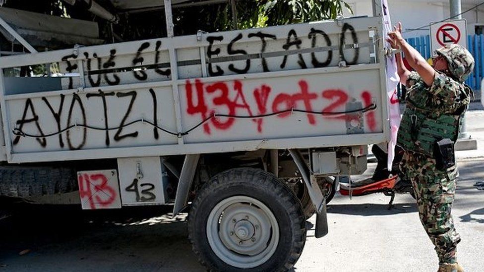 A soldier remains next to a military vehicle after a protest demanding justice and clarification of the disappearance of 43 students from Ayotzinapa, on 12 January, 2015.