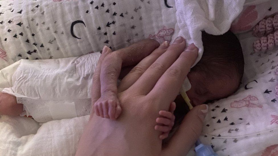 Baby Imogen being held by her mums hand