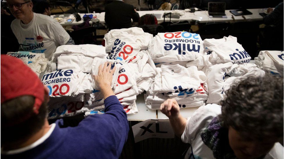 Supporters pick out t-shirts during a rally for Democratic presidential candidate former New York City Mayor Mike Bloomberg in Nashville, TN