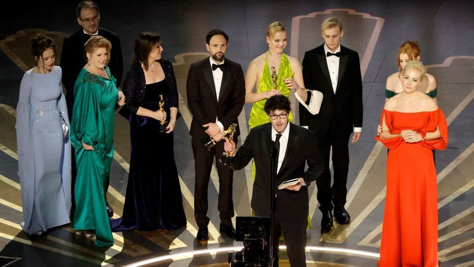 Daniel Roher (Front) accepts the Best Documentary Feature award for "Navalny"