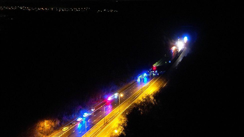 Emergency service crews on the M23 with Crawley in the distance