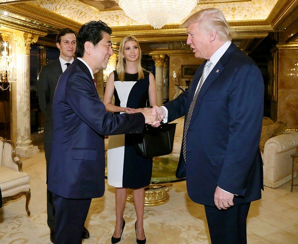 This handout picture, released by Japan's Cabinet Secretariat on November 18, 2016 shows Japanese Prime Minister Shinzo Abe (2nd L) being welcomed by US President-elect Donald Trump (R) beside Ivanka Trump (C) and her husband Jared Kushner (L) in New York