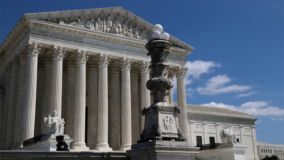 A lone police officer stands in front of the US Supreme Court amid the coronavirus outbreak