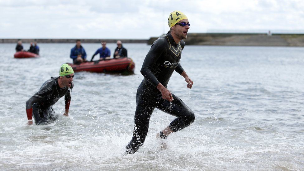 Participants in the water at Roker for the swim leg of the triathlon events