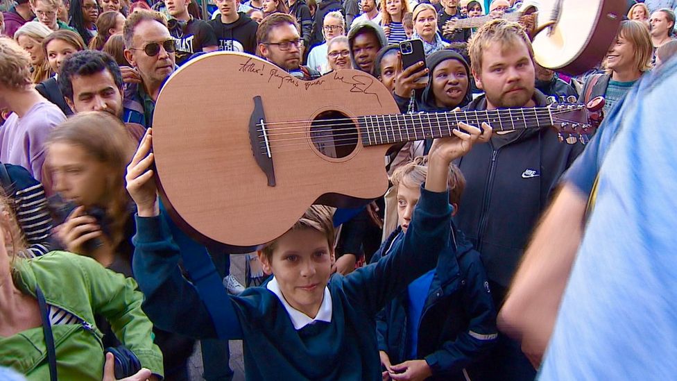 Arthur holding a guitar Ed Sheeran gave him