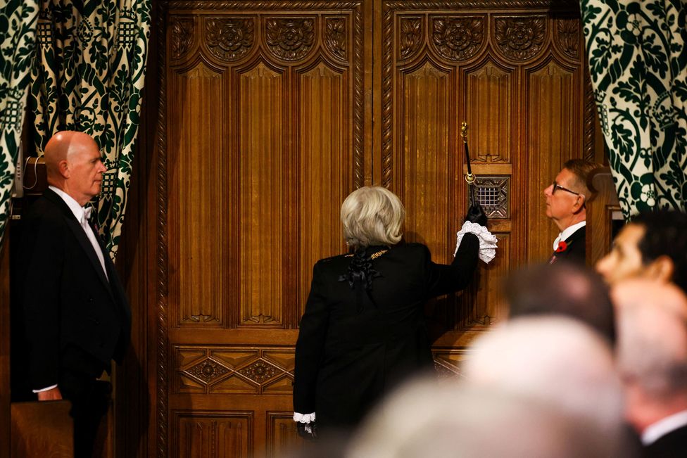 Black Rod Sarah Clarke, strikes the staff of office on the doors of the Commons chamber during the State Opening of Parliament in the House of Lords, London