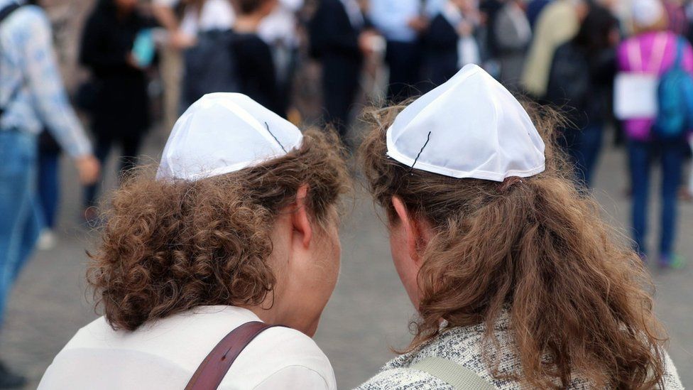 Two women wear the kippah during a gathering of the "Show Face and Kippah" march in Frankfurt am Main, central Germany on May 14, 2018