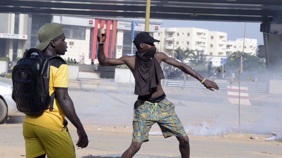 A protestor throws a rock during a demonstration of members of the Guinean opposition,