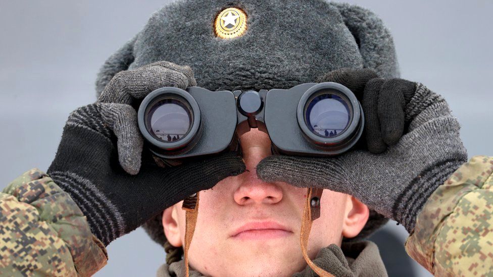 A serviceman of the Russian Southern Military District's 150th Rifle Division looks through binoculars during a military exercise at Kadamovsky Range, Rostov region, 27 January