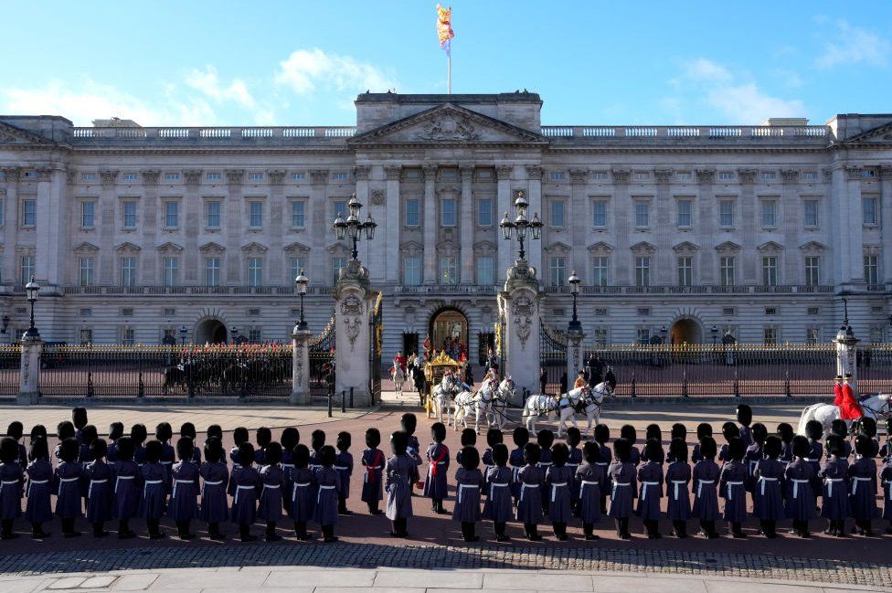Members of the King's Guard line up outside Buckingham Palace as King Charles III and Queen Camilla depart in the Diamond Jubilee State Coach for the Houses of Parliament ahead of the State Opening of Parliament on November 7, 2023 in London, England.