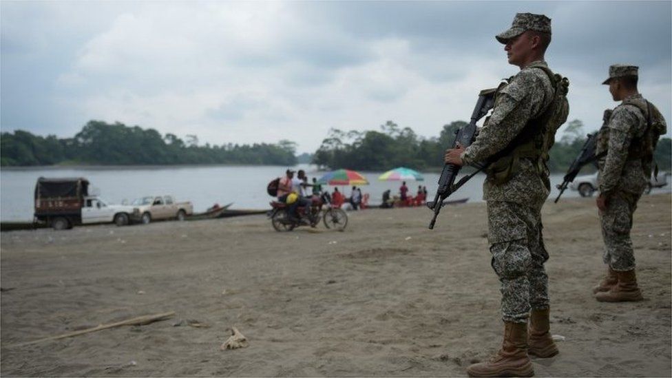 Colombian marines stand guard along the Mira river in Imbili, Tumaco Municipality, in the Colombian department of Narino near the border with Ecuador, on April 15, 2018.