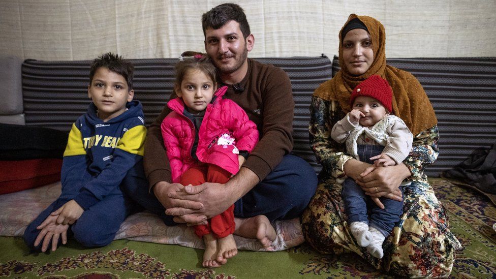 Deiri Fayyad sits with his wife Yamama and their three children