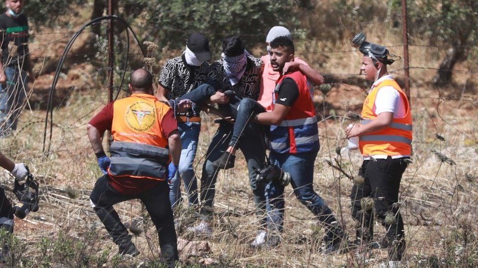 A protestor is injured following during a clash with Israeli police