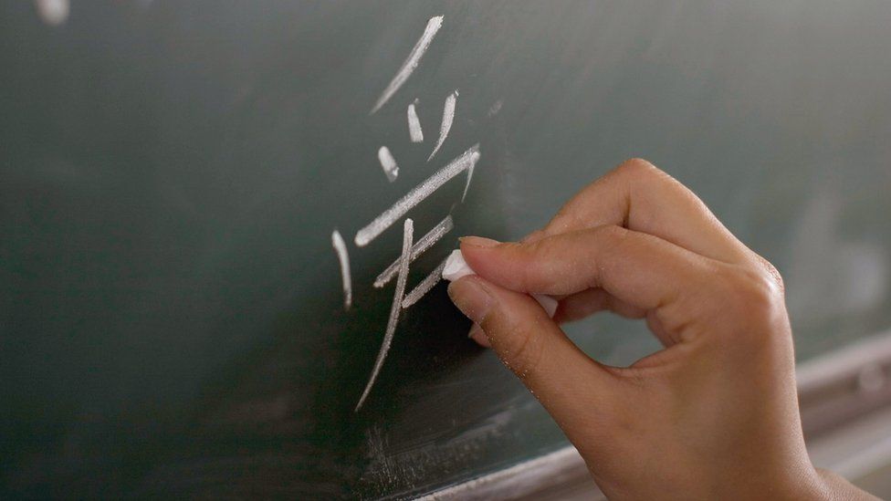 A teacher writes the Chinese character of "Love" during a class at a school in Dujiangyan, Sichuan province, China, 1 June 2008