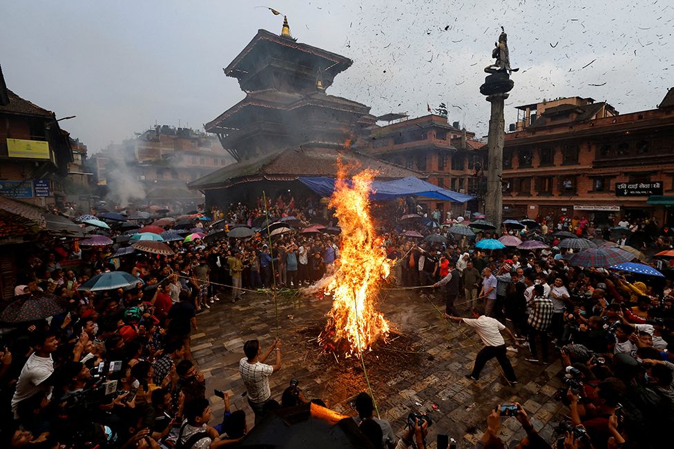 An effigy of demon Ghantakarna is burnt to symbolizs the destruction of evil during the Ghantakarna festival in Bhaktapur, Nepal, on 26 July 2022