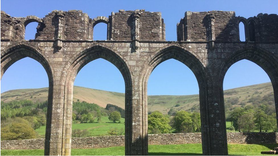The ruins of Llanthony Priory against a clear blue sky