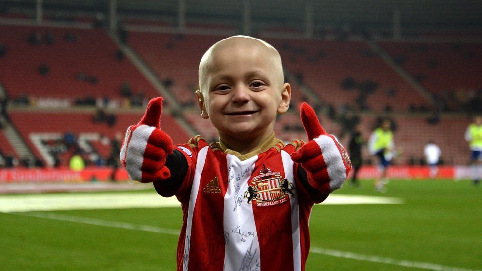 Bradley Lowery gives a thumbs-up on the Stadium of Light pitch