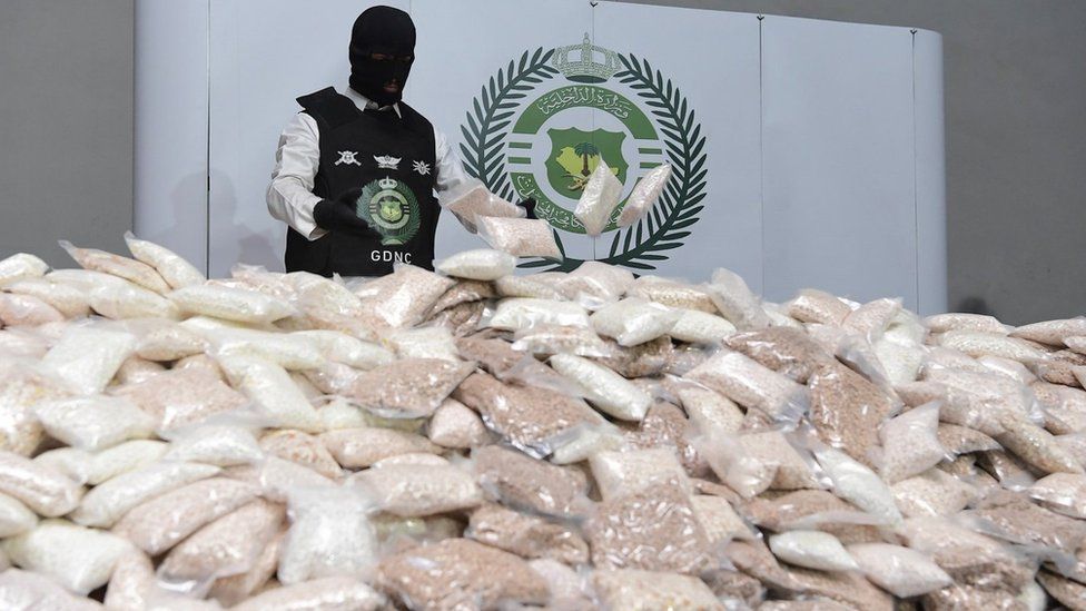 A Saudi ant-narcotics agent inspects a shipment of 46 million amphetamine pills seized in Riyadh (31 August 2022)