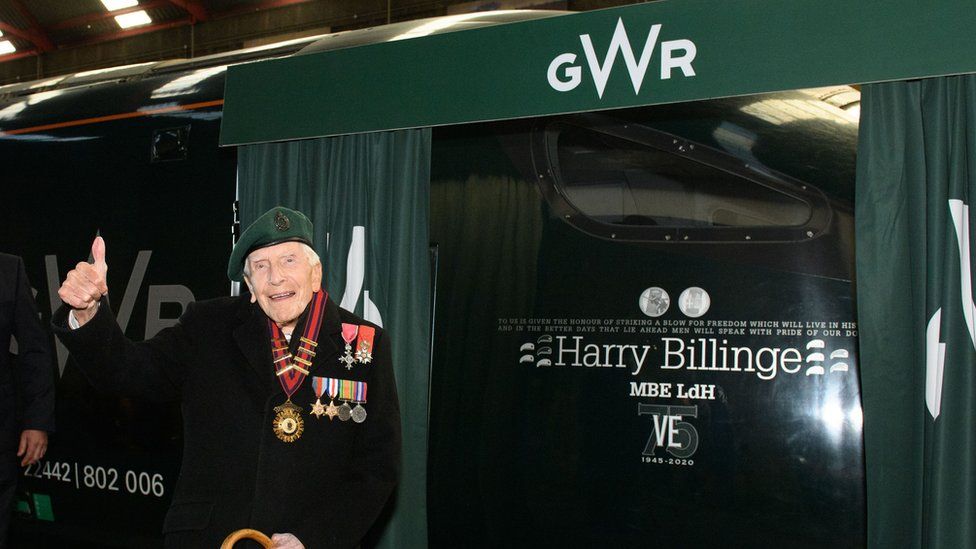 Harry Billinge in front of a train with his name on it