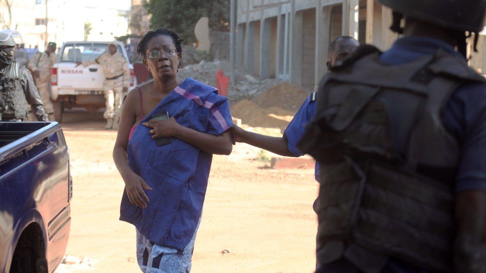 Malian security forces escort a hostage freed from the Radisson Blu hotel in Bamako, Mali on November 20, 2015.
