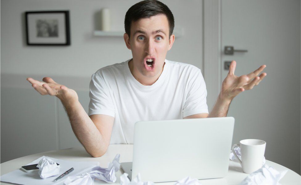 Exasperated man in front of laptop