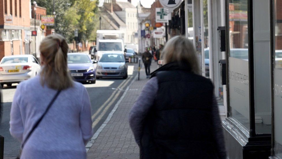 Backs of two women walking down street in Coleshill