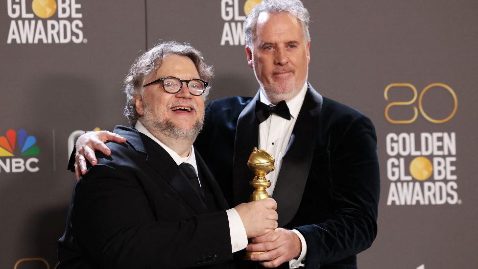 Guillermo del Toro and Mark Gustafson with the award for best animated picture for Pinocchio