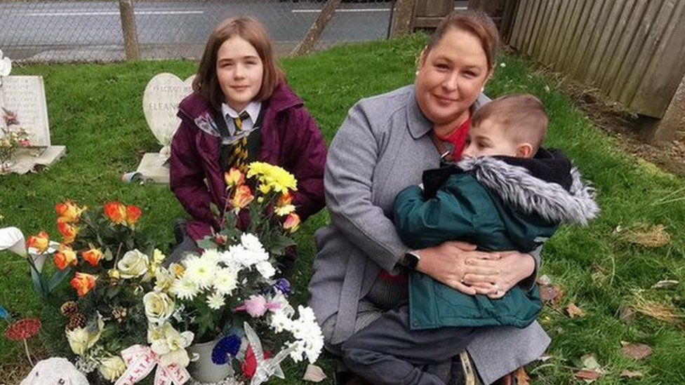 Katie and her children at Oscar's grave