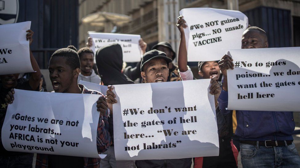 Anti-vaccination protesters in South Africa holding placards saying "we are not guinea pigs"