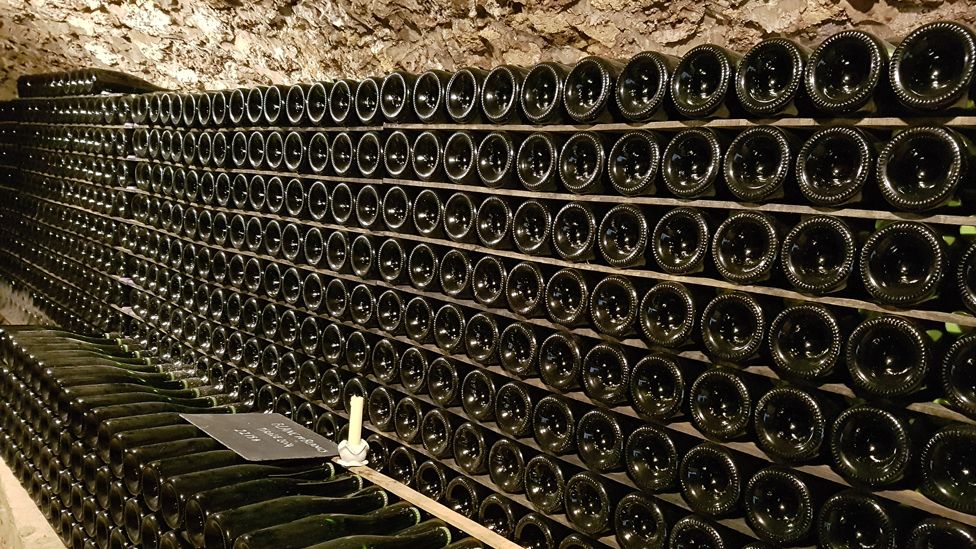 Champagne lying in racks in the cellar