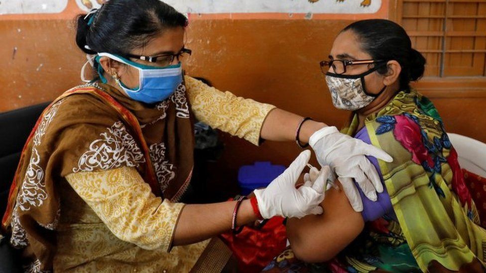A health care worker receives a dose of COVISHIELD, a COVID-19 vaccine manufactured by Serum Institute of India