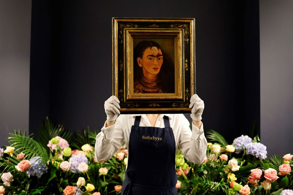 An assistant displays the artwork entitled Diego y yo (Diego and I) by Mexican painter Frida Kahlo at Sotheby's auction house in central London on October 21, 2021