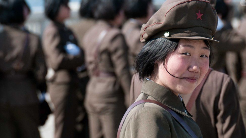 Female officer smiles at camera