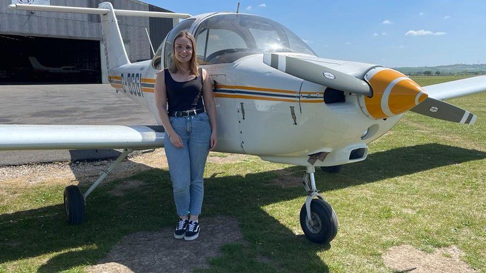 Bethan in front of a light aircraft