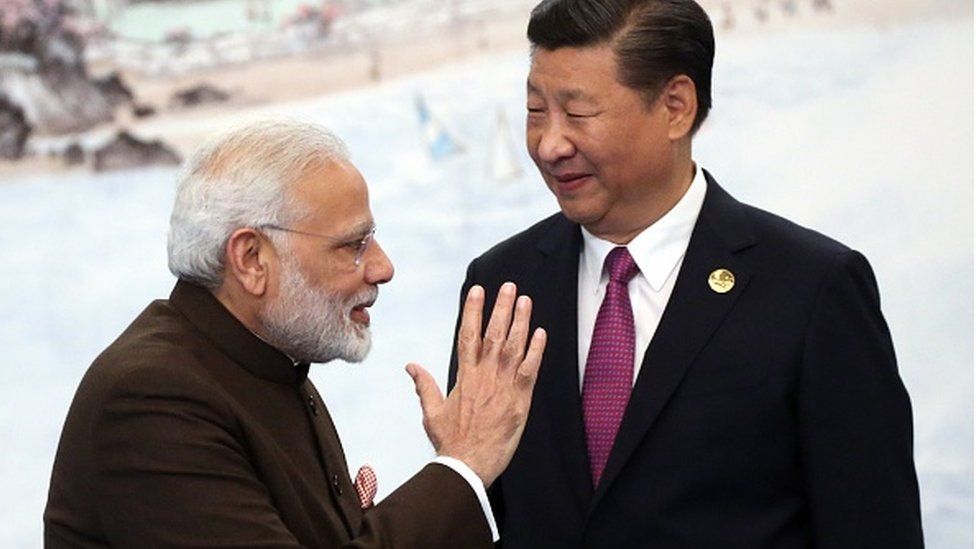 Prime Minister Narendra Modi (L) greets Chinese President Xi Jinping (R) prior to the dinner on September 4, 2017 in Xiamen, China