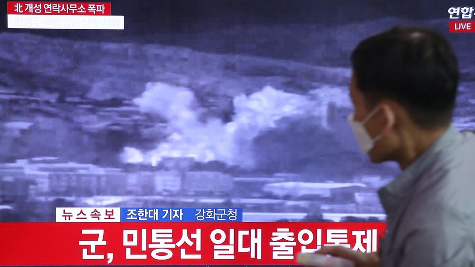 A person watches breaking news regarding the destruction of the inter-Korean liaison office in Kaesong