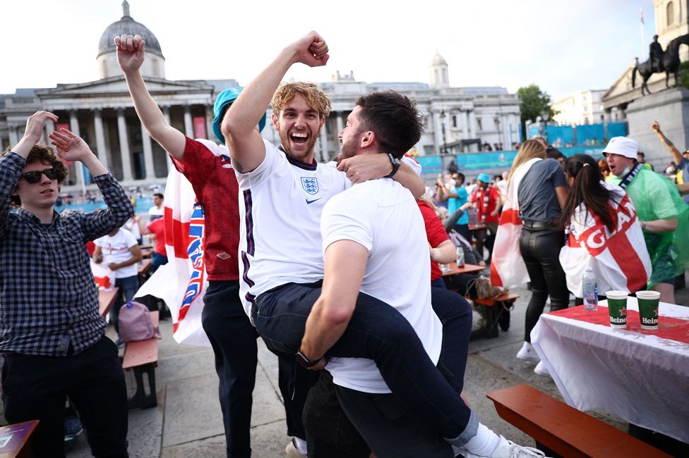 Fans gather in London ahead of Ukraine v England - London, Britain - July 3, 2021 England fans in Trafalgar Square celebrate scoring their first goal