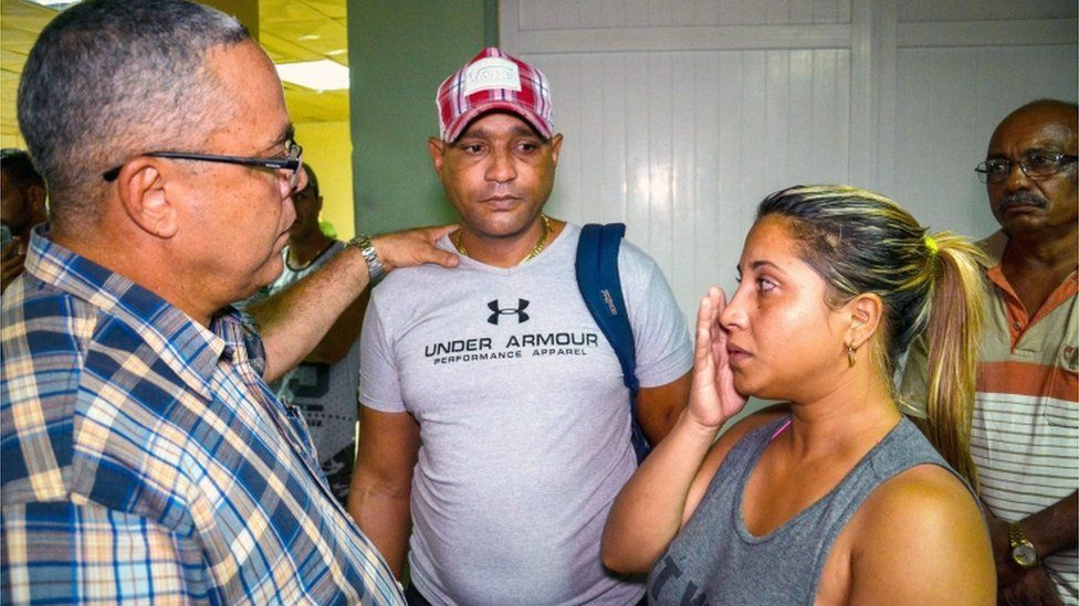 The first secretary of Communist Party in the Cuban city of Holguin, Luis Antonio Torres Iribar, speaks with relatives of the crash victims at Holguin airport