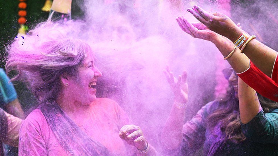 Women smeared in Holi colours in Chennai in southern India's Tamil Nadu