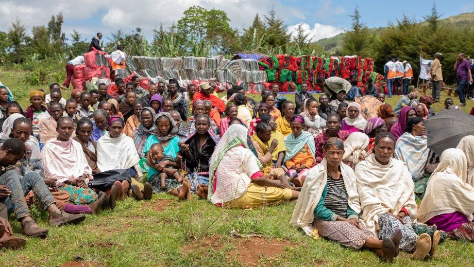 A group of Internally Displaced People ( IDP ) waits for aid distribution near their shelters on May 20, 2019 at Qercha village, Southern Ethiopia