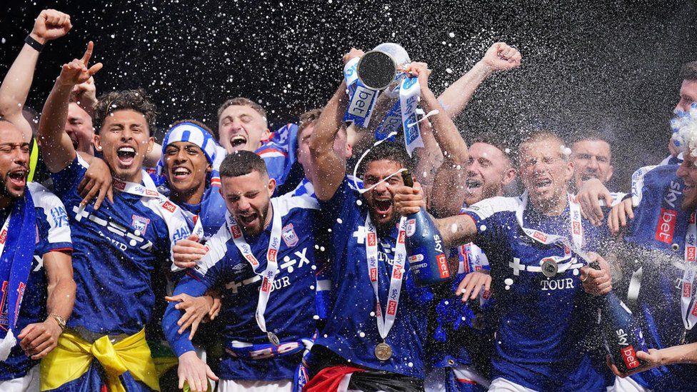 Ipswich Town players celebrate promotion with second-place trophy aloft