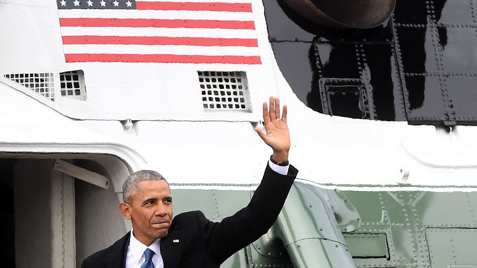 Former President Obama waves from the helicopter he departs the US Capitol after inauguration ceremonies in Washington, DC