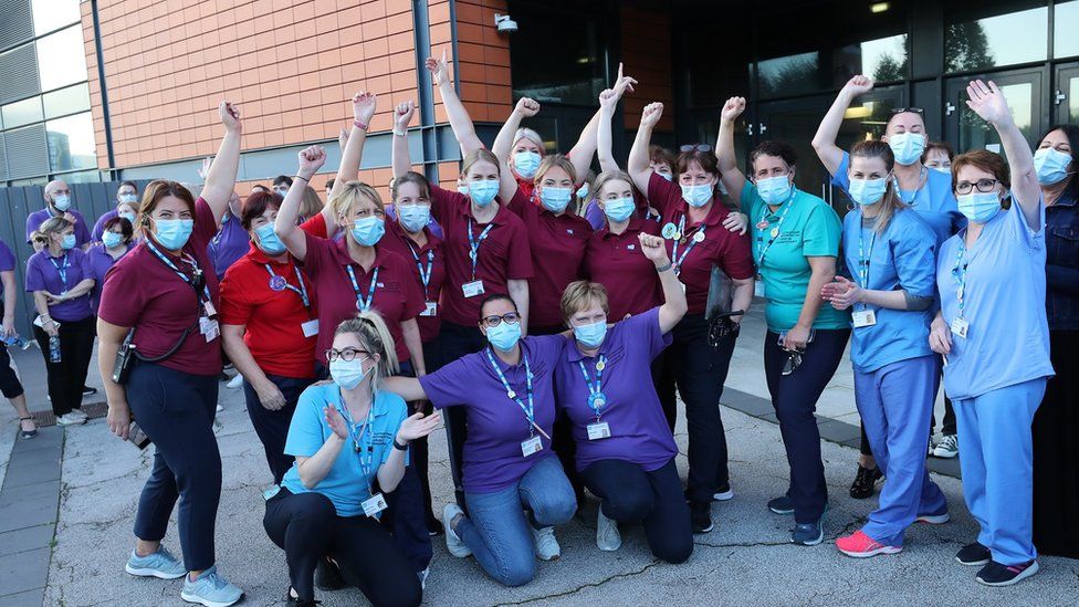 vaccine clinic staff celebrate outside the SSE Arena, Belfast at the end of The Big Jab Weekend