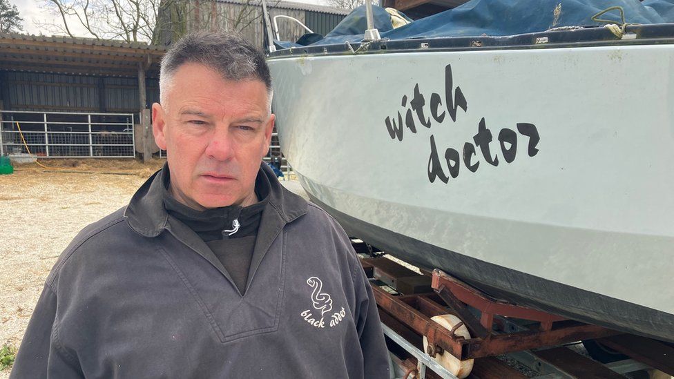 Jonathan Price Jones in front of his boat