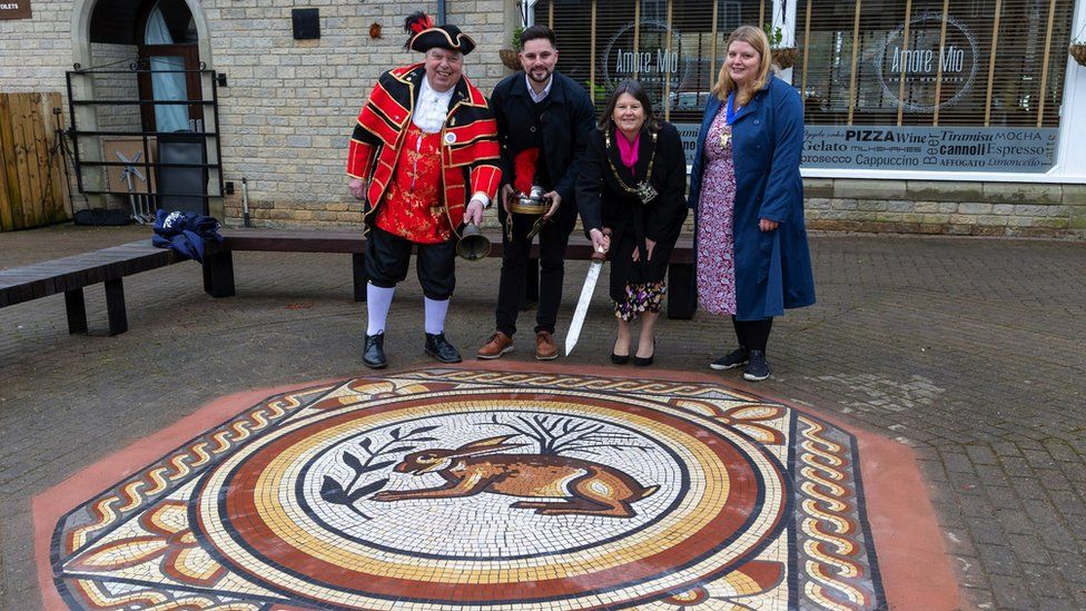 Image of Cotswold District Councillors standing by the hare mosaic