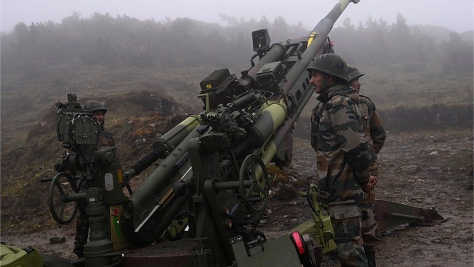Indian Army soldiers stand next to a M777 Ultra Lightweight Howitzer positioned at Penga Teng Tso ahead of Tawang, near the Line of Actual Control (LAC),
