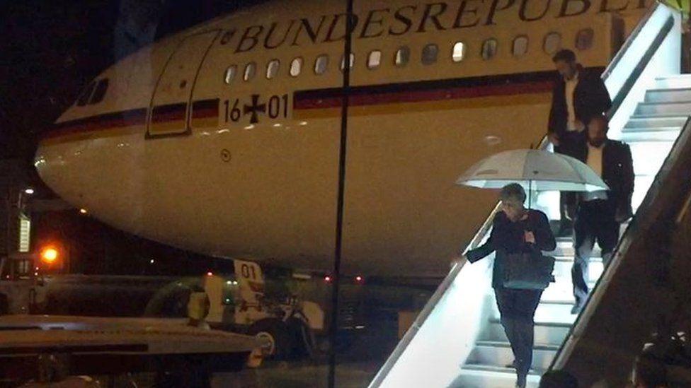 German Chancellor Angela Merkel steps down from Airbus "Konrad Adenauer" on late November 29, 2018 on the tarmac of Cologne"s airport after an emergency landing