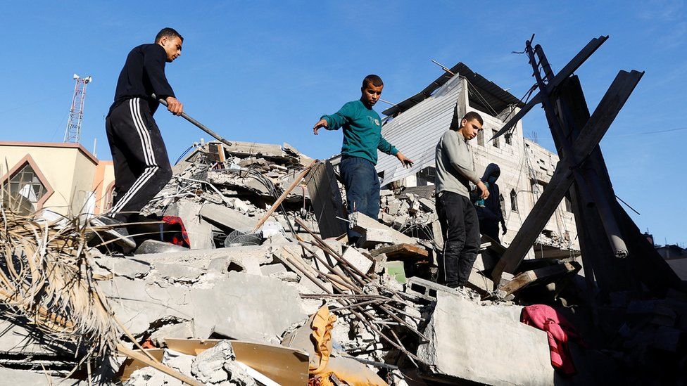 Palestinians inspect the damage at the site of Israeli strikes on houses, amid the ongoing conflict between Israel and the Palestinian Islamist group Hamas, in Khan Younis in the southern Gaza Strip, December 10, 2023