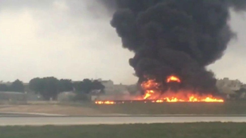 A plane on fire at Malta airport.